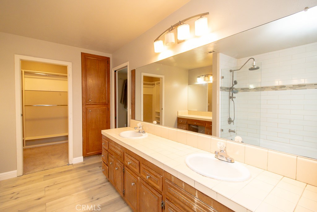 20376 Tonawanda Road Apple Valley, CA 92307 - Photo 29 of 67 a bathroom with a double vanity sink and a mirror