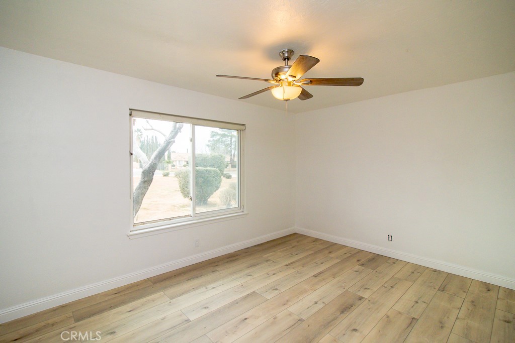 20376 Tonawanda Road Apple Valley, CA 92307 - Photo 34 of 67 an empty room with a window and ceiling fan