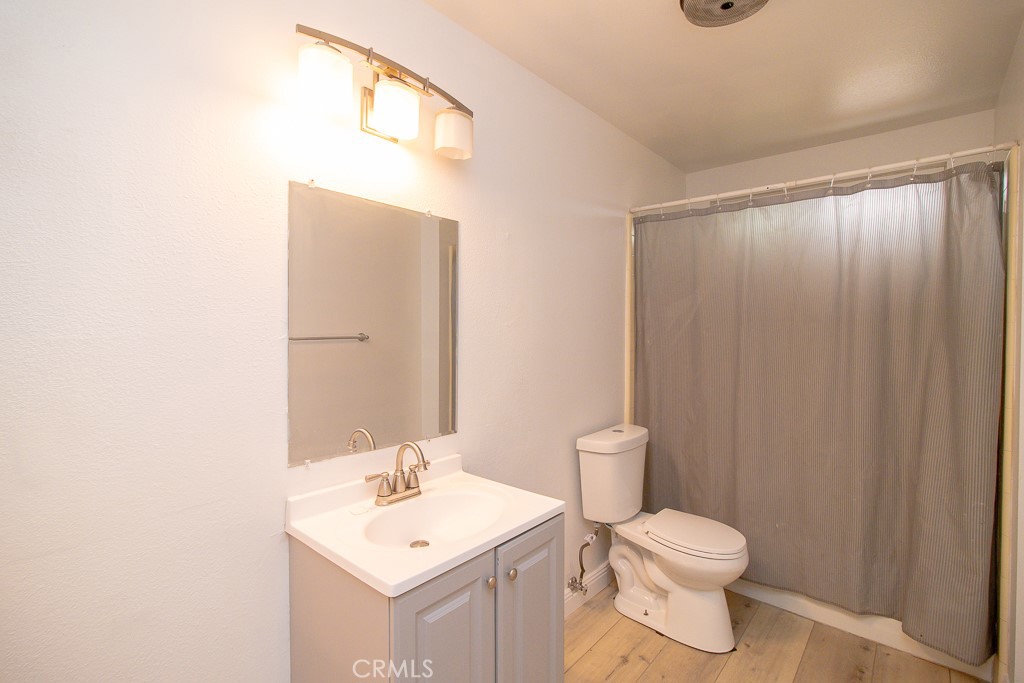 20376 Tonawanda Road Apple Valley, CA 92307 - Photo 36 of 67 a bathroom with a toilet a sink and mirror