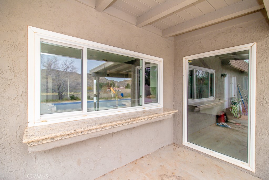 20376 Tonawanda Road Apple Valley, CA 92307 - Photo 44 of 67 a view of a glass door with a glass door and a porch