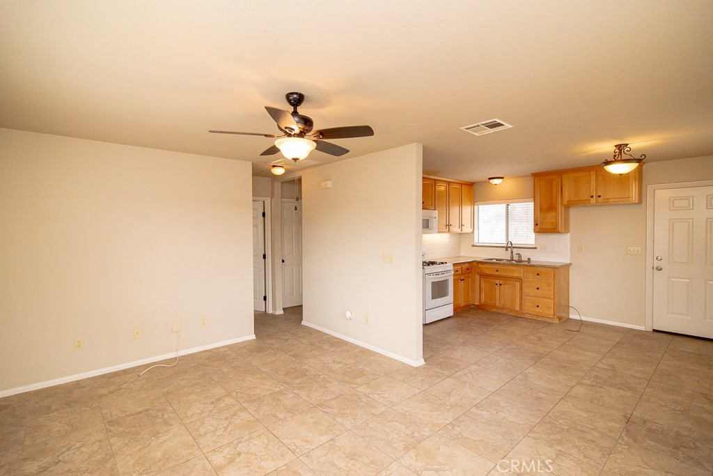 20376 Tonawanda Road Apple Valley, CA 92307 - Photo 51 of 67 a view of a kitchen with a sink and a refrigerator