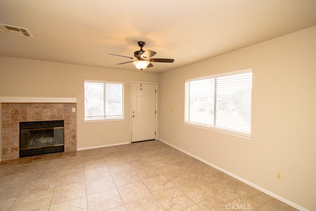 20376 Tonawanda Road Apple Valley, CA 92307 - Photo 52 of 67 a view of an empty room with a fireplace and a window