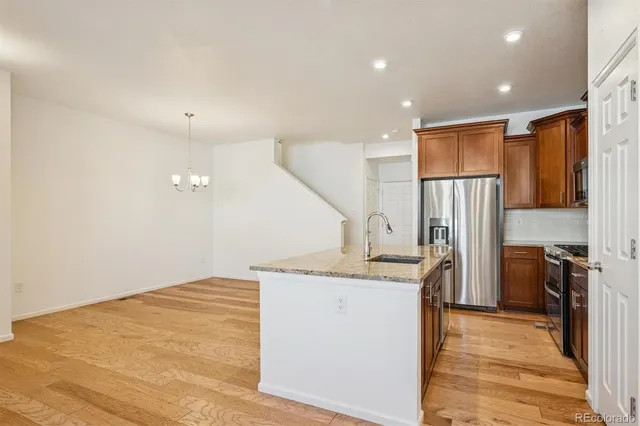 a kitchen with stainless steel appliances granite countertop a refrigerator stove and microwave