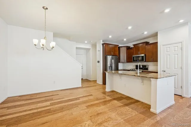a view of a room with wooden floor and ceiling fan