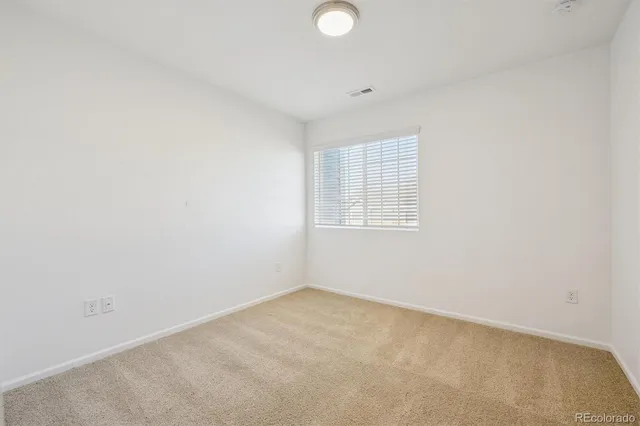 a bedroom with a bed couch and a window