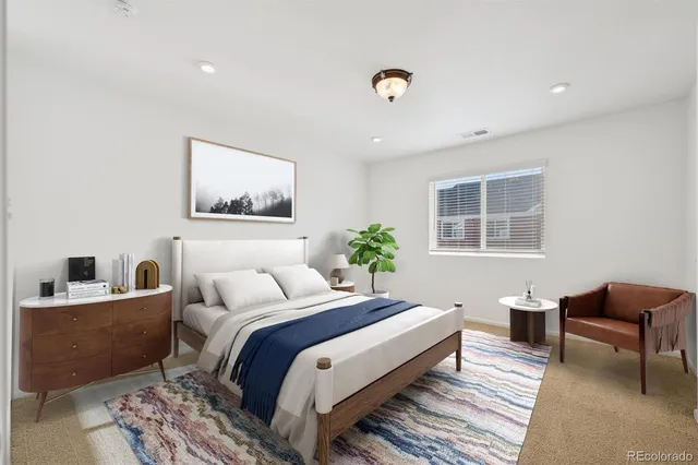 a bedroom with a bed and a potted plant