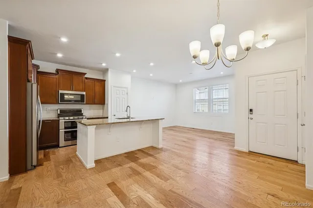 a view of a kitchen with a sink stainless steel appliances