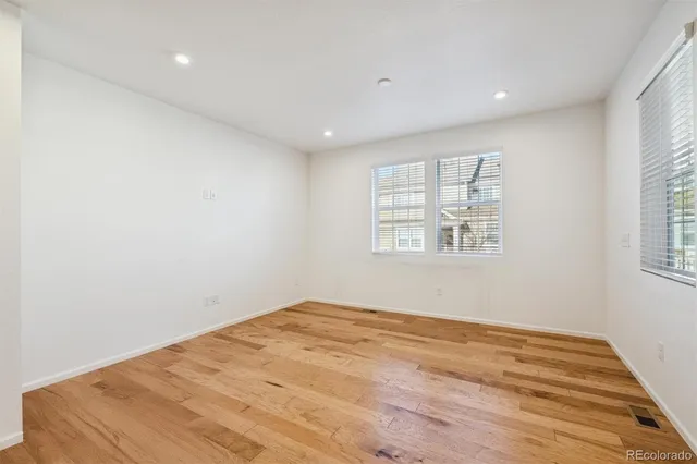 a view of kitchen with kitchen island a sink wooden floor and view living room