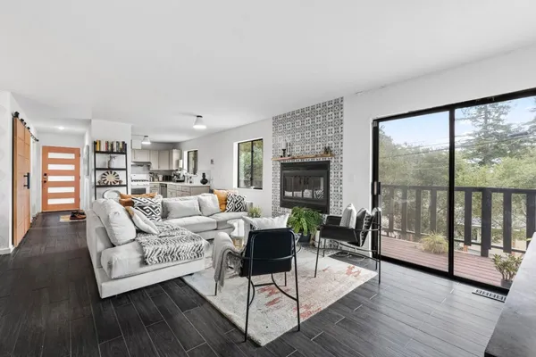 a living room with furniture a fireplace and a flat screen tv