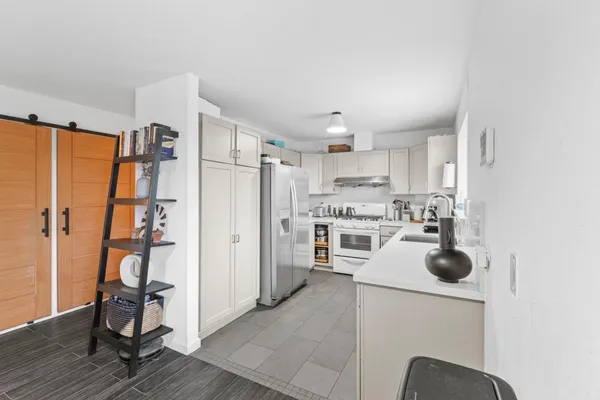 a kitchen with a refrigerator and a sink