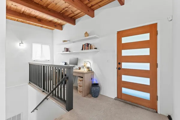 a bedroom with bed and a chandelier