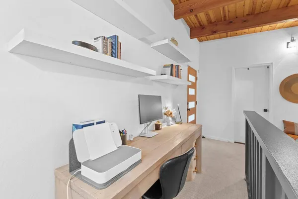 a large bed sitting in a bedroom next to a window