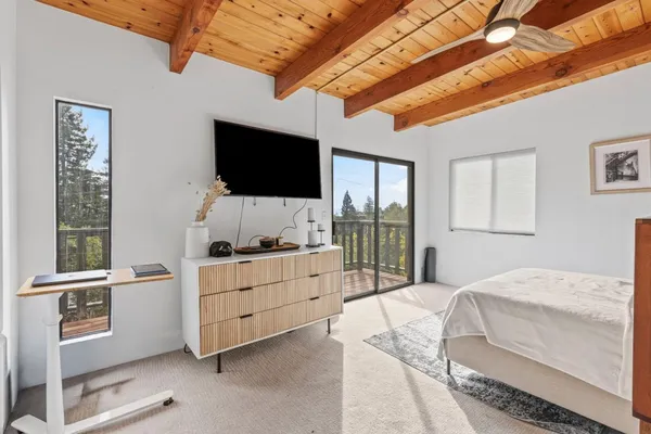 a bedroom with a bed and a flat screen tv