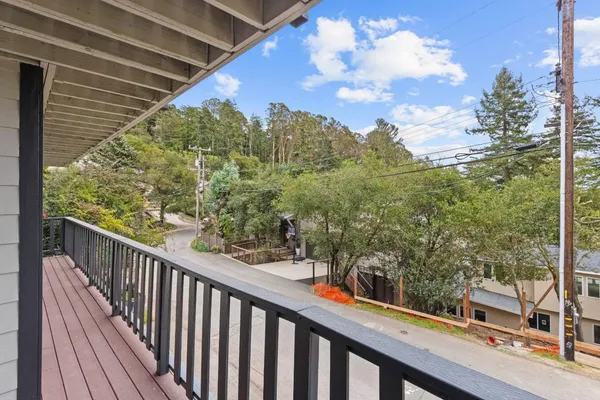 a view of a balcony with wooden floor
