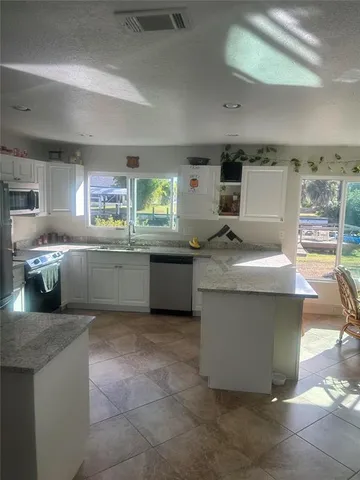 a kitchen with a sink and a stove top oven