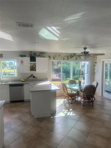 a living room with furniture and large windows