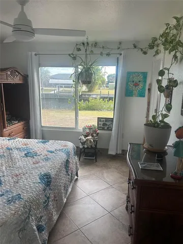 a bedroom with furniture and a large window