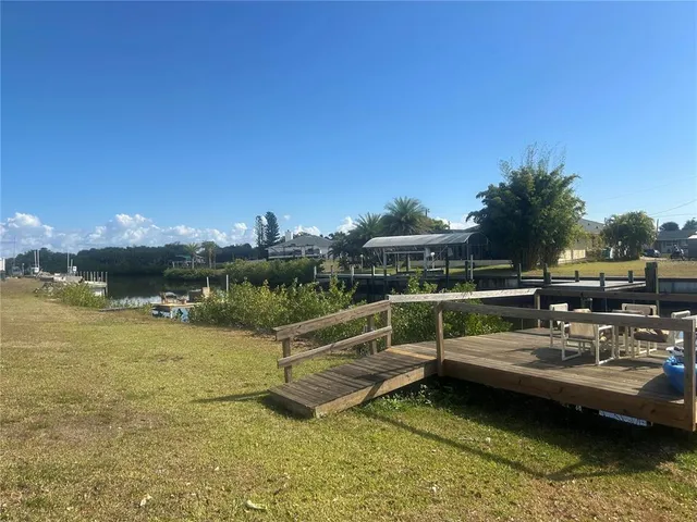 a view of swimming pool with outdoor seating and yard in the back