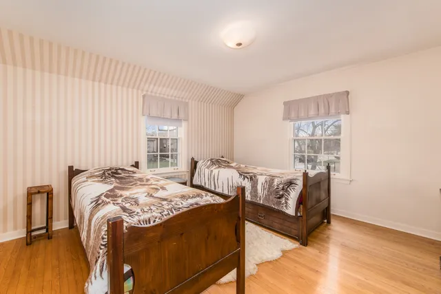 a bedroom with bed and a window