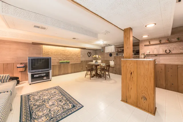a view of a kitchen with furniture and a refrigerator