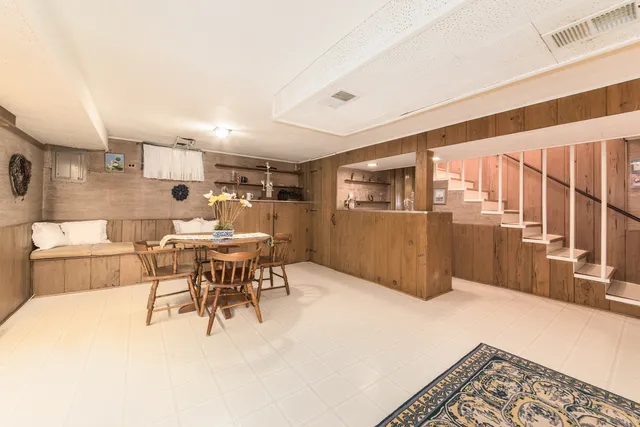 a dining room with a table and chairs