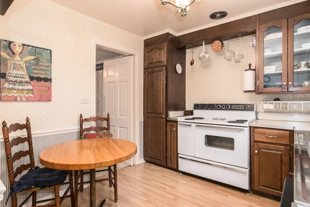 a view of a kitchen with a stove a sink and a refrigerator