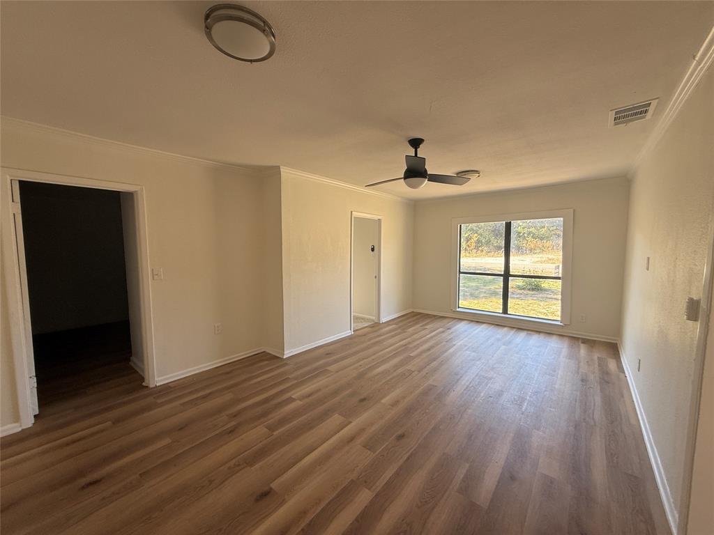 1102 Chilton Street Weatherford, TX 76086 - Photo 11 of 28 wooden floor in an empty room with a window