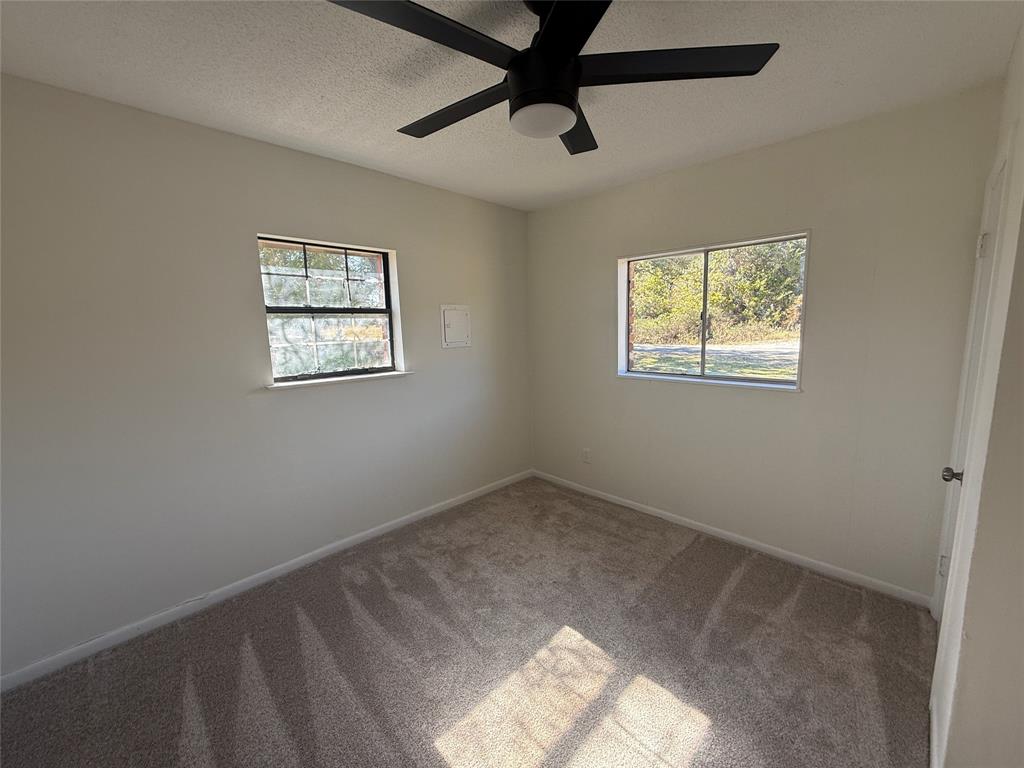 1102 Chilton Street Weatherford, TX 76086 - Photo 12 of 28 a view of room with hardwood floor and window