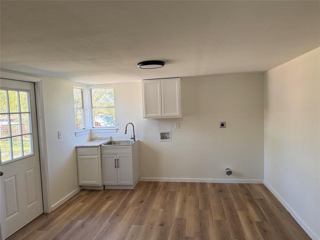 1102 Chilton Street Weatherford, TX 76086 - Photo 14 of 28 a room with a sink cabinets and wooden floor