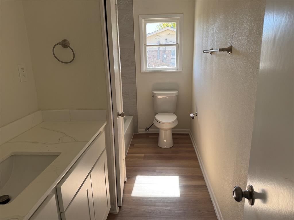 1102 Chilton Street Weatherford, TX 76086 - Photo 17 of 28 a bathroom with a toilet and a shower