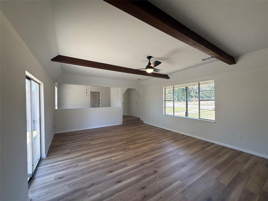 1102 Chilton Street Weatherford, TX 76086 - Photo 2 of 28 a view of an empty room with wooden floor and a window
