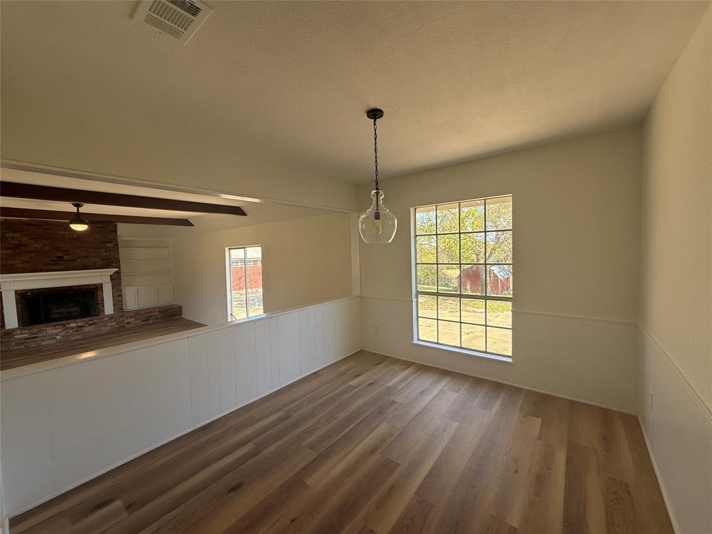 1102 Chilton Street Weatherford, TX 76086 - Photo 4 of 28 a view of an empty room with window and wooden floor