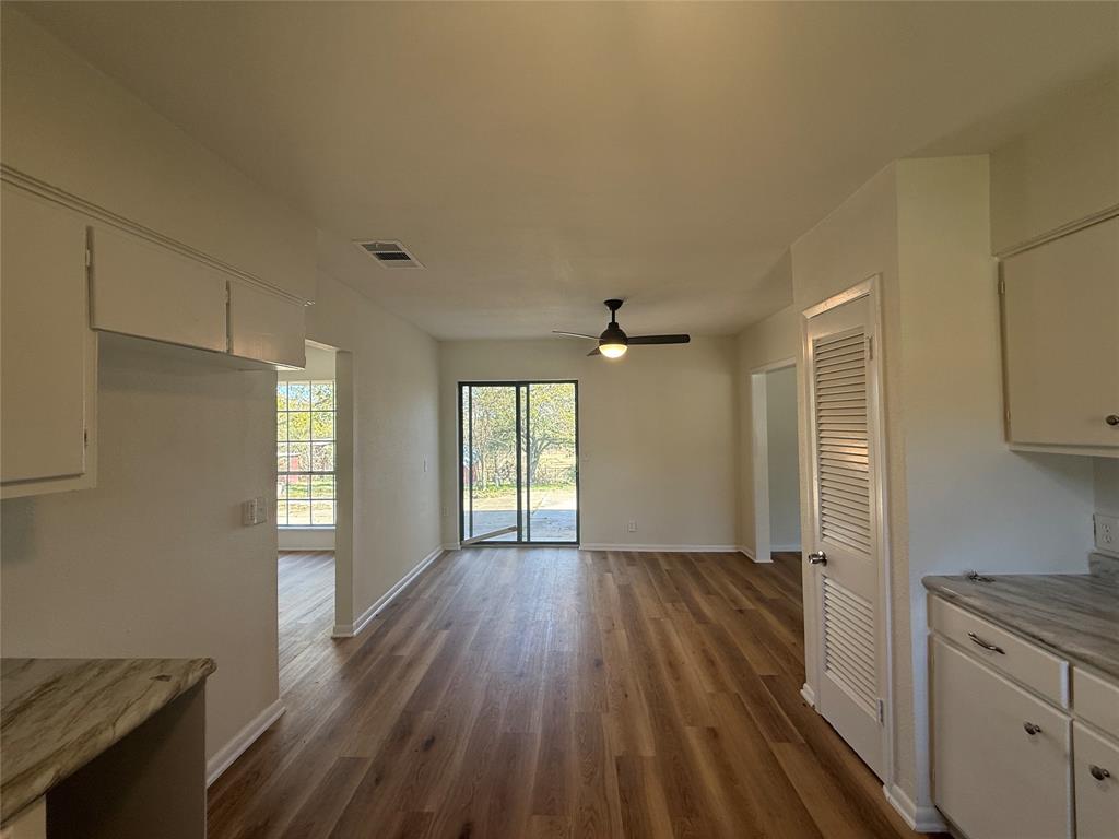 1102 Chilton Street Weatherford, TX 76086 - Photo 8 of 28 an empty room with wooden floor and windows