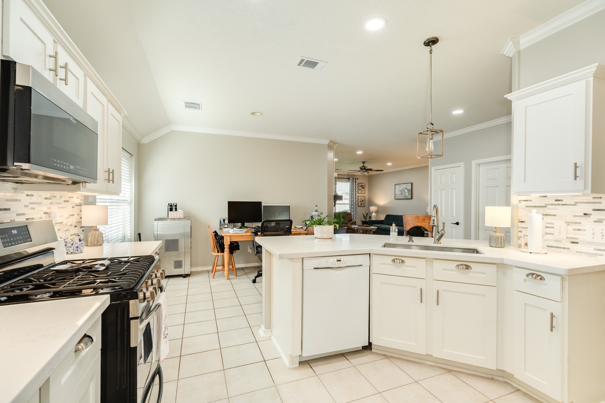13808 Stark Bridge Lane Rosharon, TX 77583 - Photo 9 of 39 Modern kitchen featuring an updated 5-burner stainless steel freestanding range, a spacious oven, and contemporary lighting fixtures throughout the space.