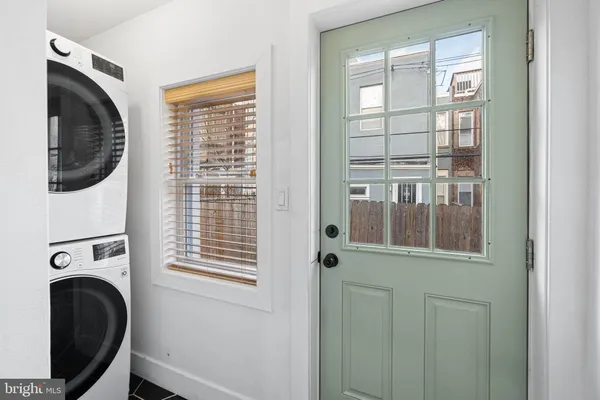 a view of a bedroom with washer and dryer