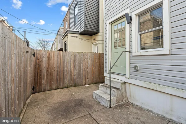 a view of a house with a door and wooden walls