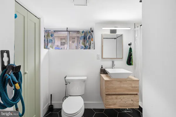 a bathroom with a toilet sink and mirror