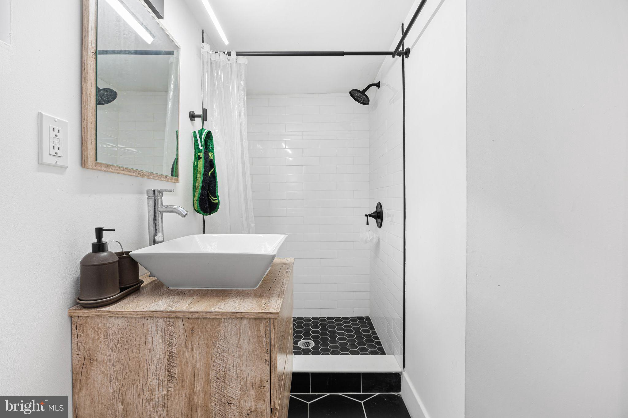 2937 Nicholas Street Philadelphia, PA 19121 - Photo 20 of 33 a bathroom with a sink and a mirror