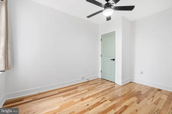 a view of a bedroom with a ceiling fan