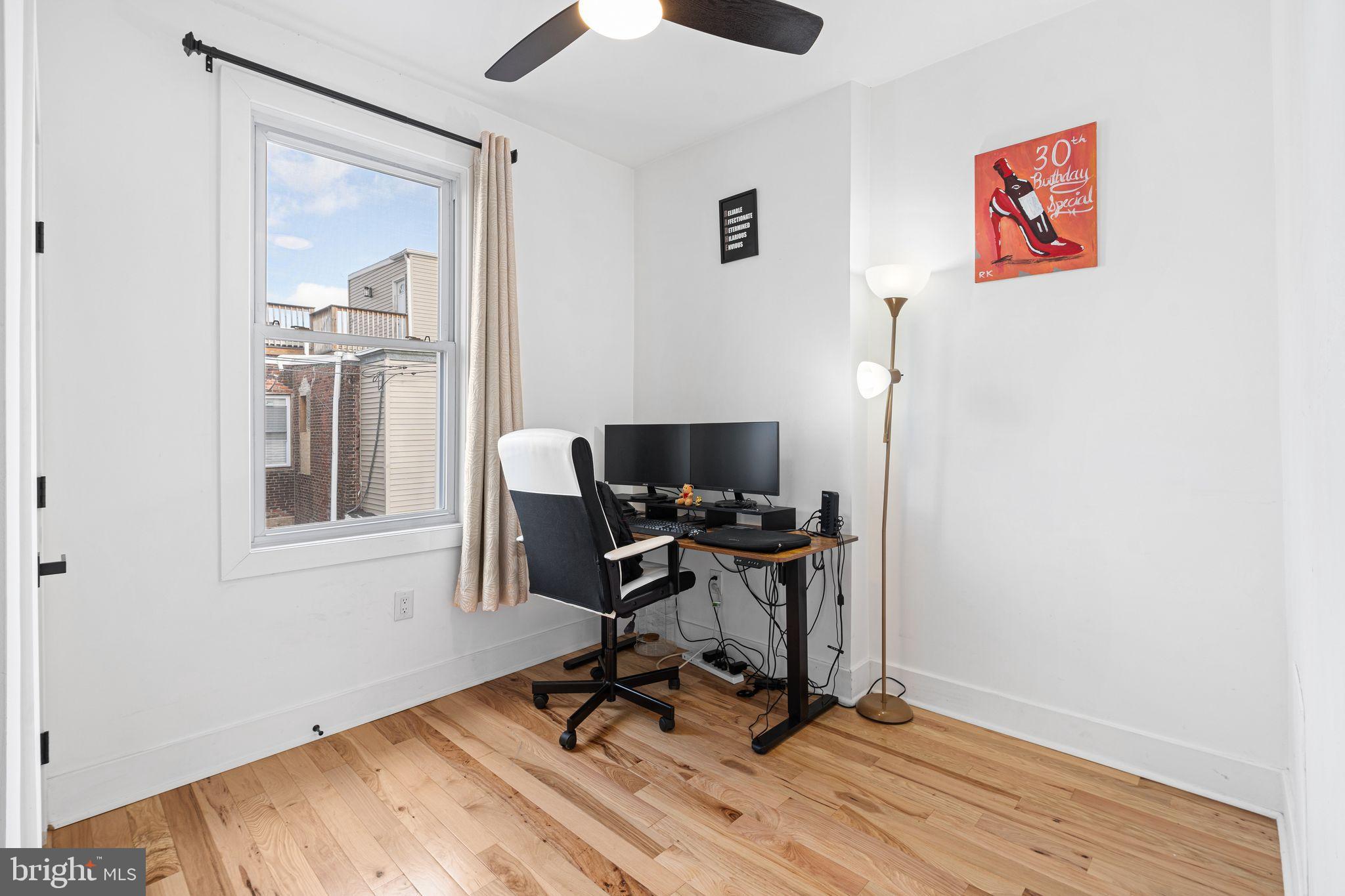 2937 Nicholas Street Philadelphia, PA 19121 - Photo 31 of 33 a view of a workspace with furniture and a window