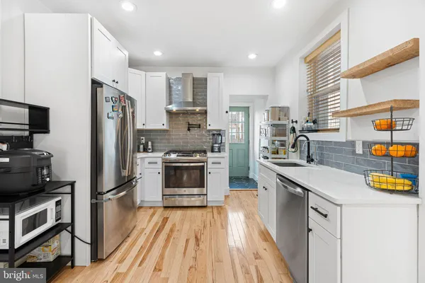 a kitchen with stainless steel appliances a refrigerator stove and sink