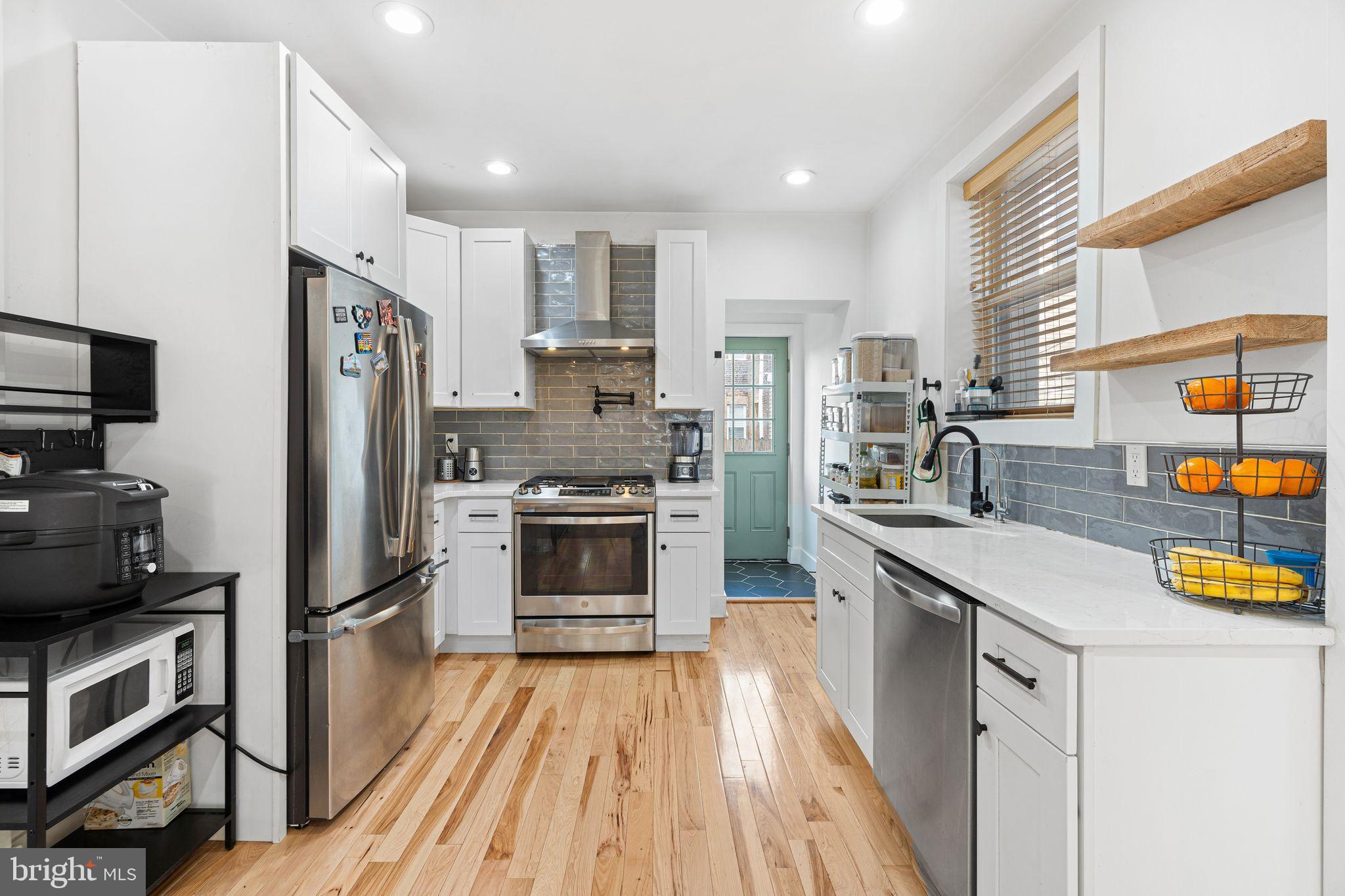 2937 Nicholas Street Philadelphia, PA 19121 - Photo 9 of 33 a kitchen with stainless steel appliances a refrigerator stove and sink