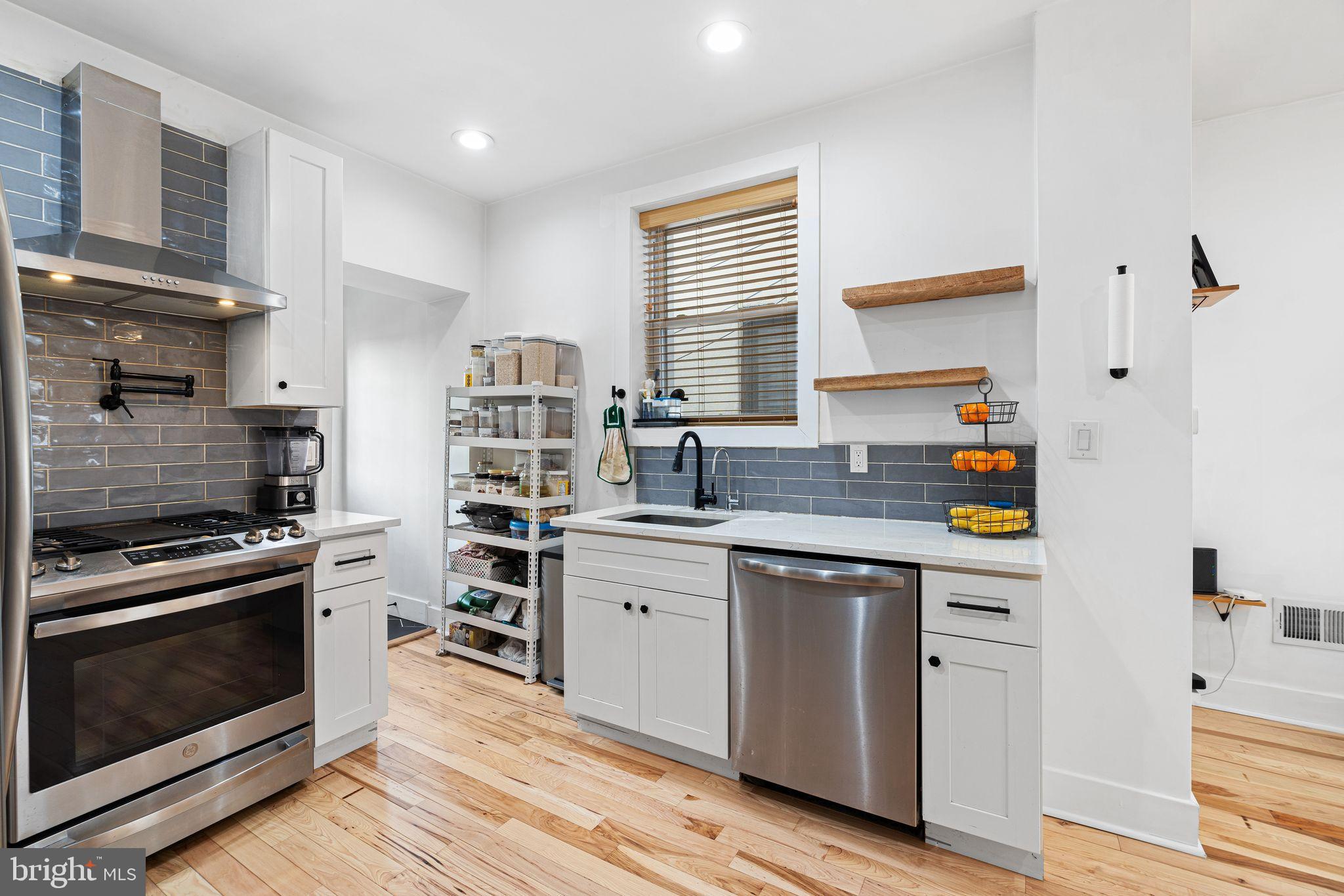 2937 Nicholas Street Philadelphia, PA 19121 - Photo 10 of 33 a kitchen with stainless steel appliances granite countertop a stove and a sink