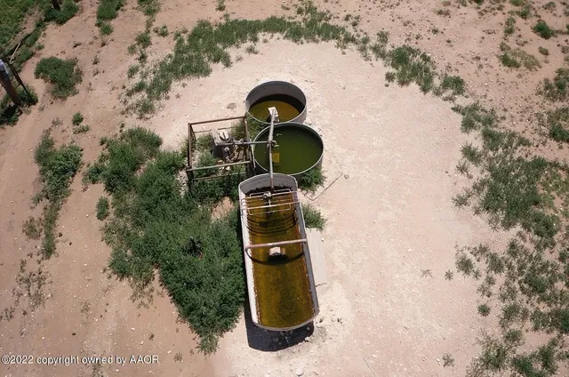 a view of a field with an ocean view