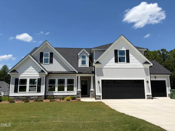 a front view of a house with a yard and garage