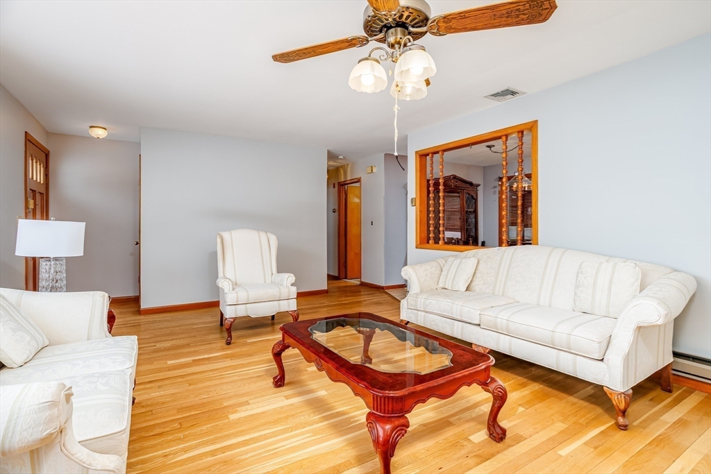 34 Robin Road Worcester, MA 01604 - Photo 11 of 42 a living room with furniture a chandelier and a rug