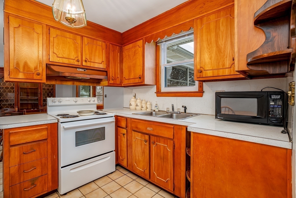 34 Robin Road Worcester, MA 01604 - Photo 16 of 42 a kitchen with stainless steel appliances granite countertop a stove a sink and a microwave