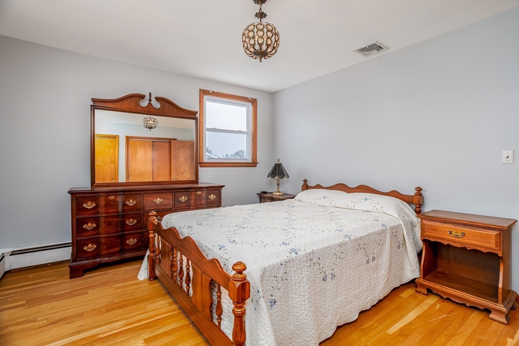 34 Robin Road Worcester, MA 01604 - Photo 25 of 42 a spacious bedroom with a bed and a dresser in it