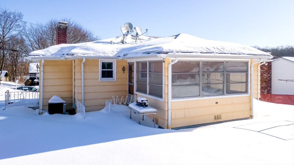 34 Robin Road Worcester, MA 01604 - Photo 6 of 42 a view of a house with a barbeque and wooden fence