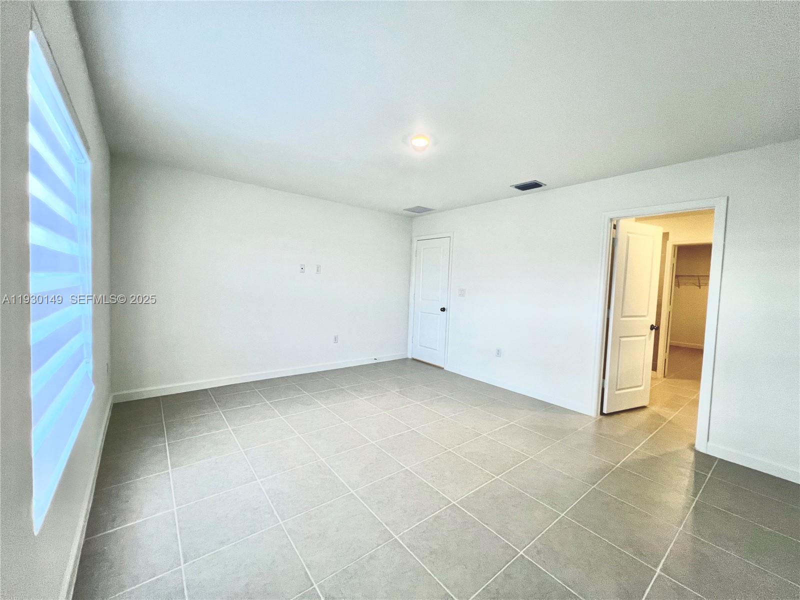 17376 Southwest 285th Street, Unit 1 Homestead, FL 33030 - Photo 13 of 32 an empty room with a bathroom